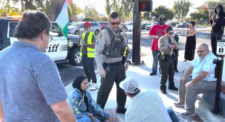 Onlookers like Paul Kessler lying on the sidewalk after he fell and hit his head during a confrontation with pro-Palestinian protesters.