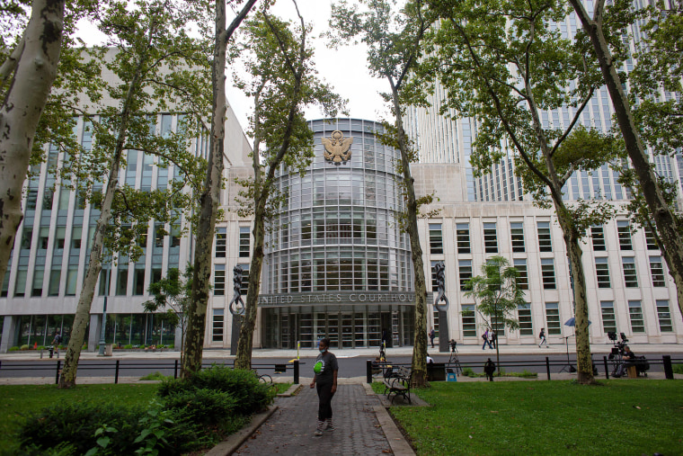 A woman stands near the Brooklyn federal court.