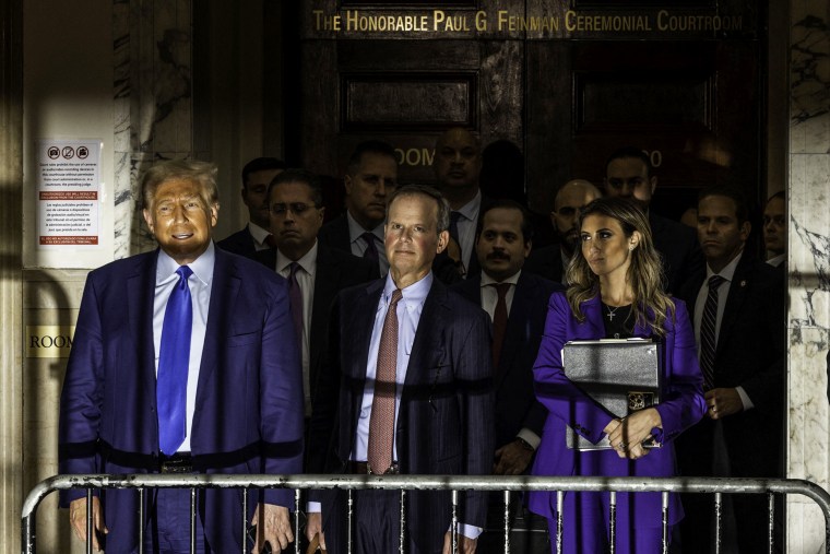 Former President Donald Trump alongside his attorneys Christopher Kise and Alina Habba outside court in New York.