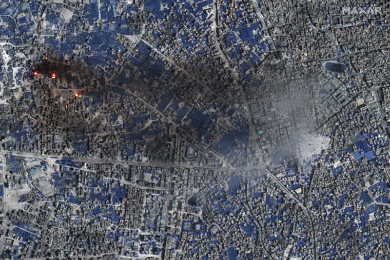 Vegetation appears in shades of blue while active fires/thermal hot spots show up as an orange/yellow bloom. 
