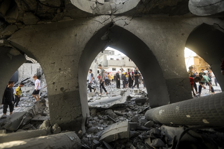 Palestinians inspect the damage of a destroyed mosque following an Israeli airstrike in Khan Younis refugee camp, southern Gaza Strip.