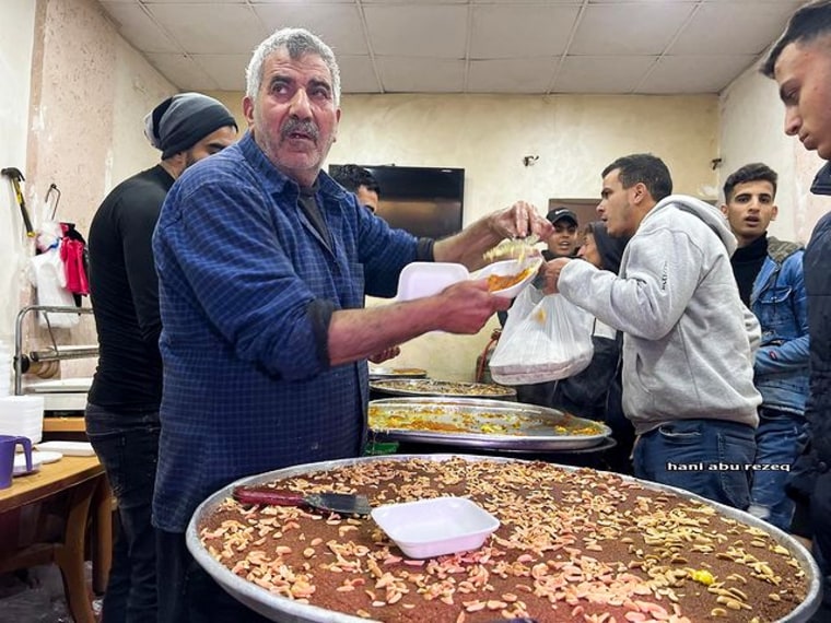 Abu Shadi filling a customer's order in his sweet shop in Gaza City.