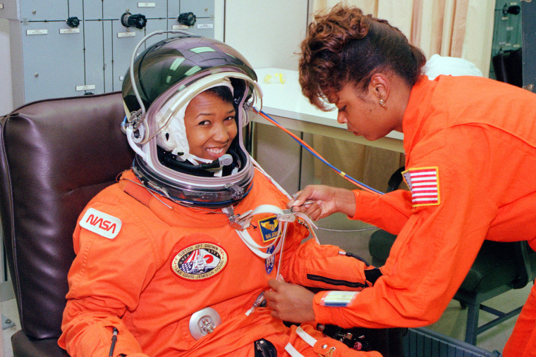 Mae Jemison smiles as a technician performs tests on her spacesuit.