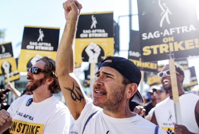 SAG-AFTRA member Brandon Alameda raises a fist with fellow striking SAG-AFTRA members and supporters in Los Angeles, Calif. on Nov. 8, 2023.