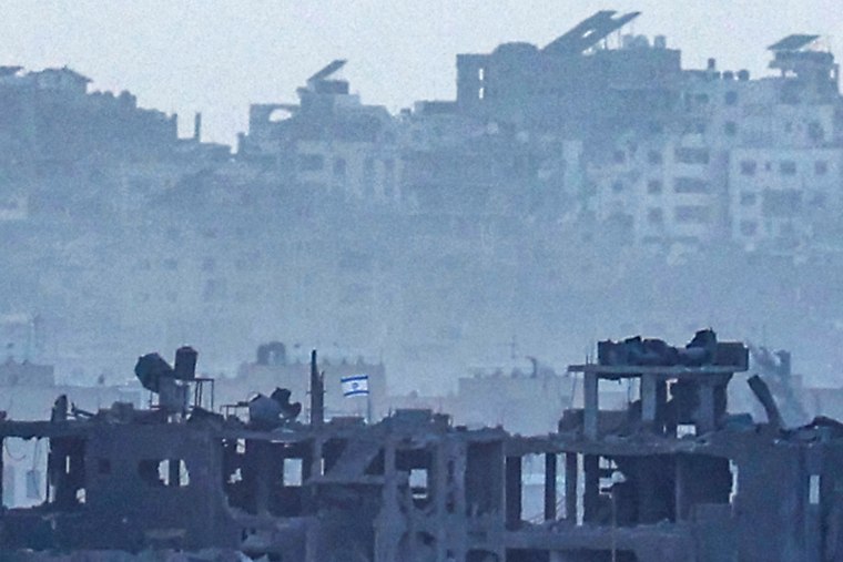 An Israeli flag flies on the top of a destroyed building in the northern Gaza Strip close to the border with southern Israel on Nov. 9, 2023.