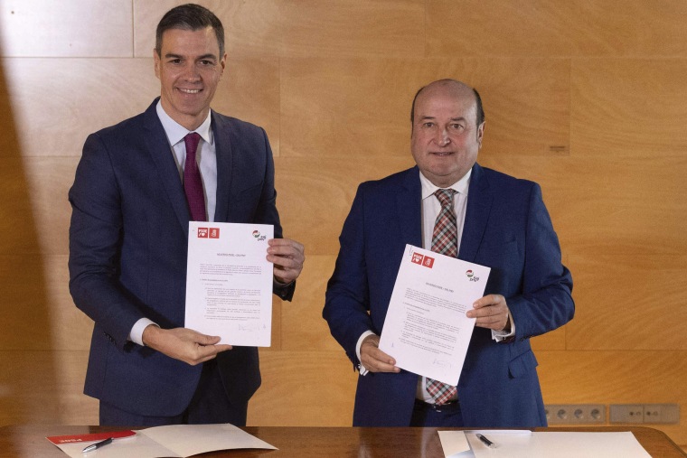 The President of the Government in office and candidate for re-election, Pedro Sánchez (left), and the President of the EBB of the PNV, Andoni Ortuzar (right), sign an agreement for the investiture, at the Congress of Deputies in Madrid, Spain