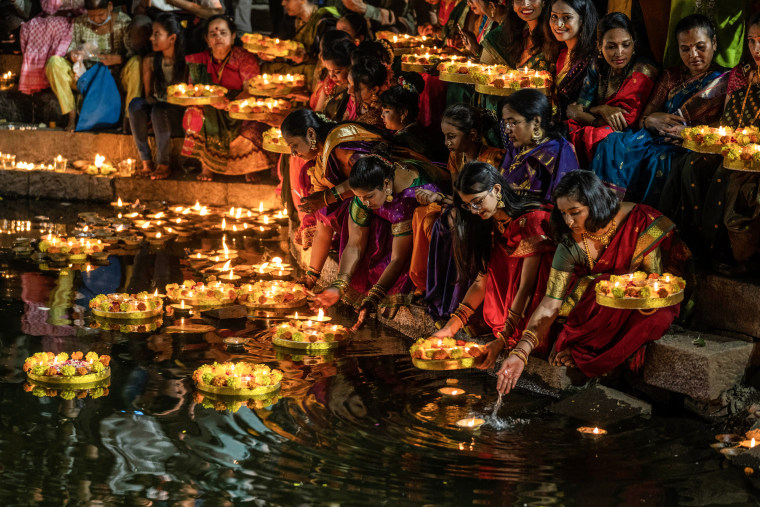 Hindu women light oil lamps as they celebrate Dev Diwali festival in Mumbai, India on Nov. 7, 2022. 