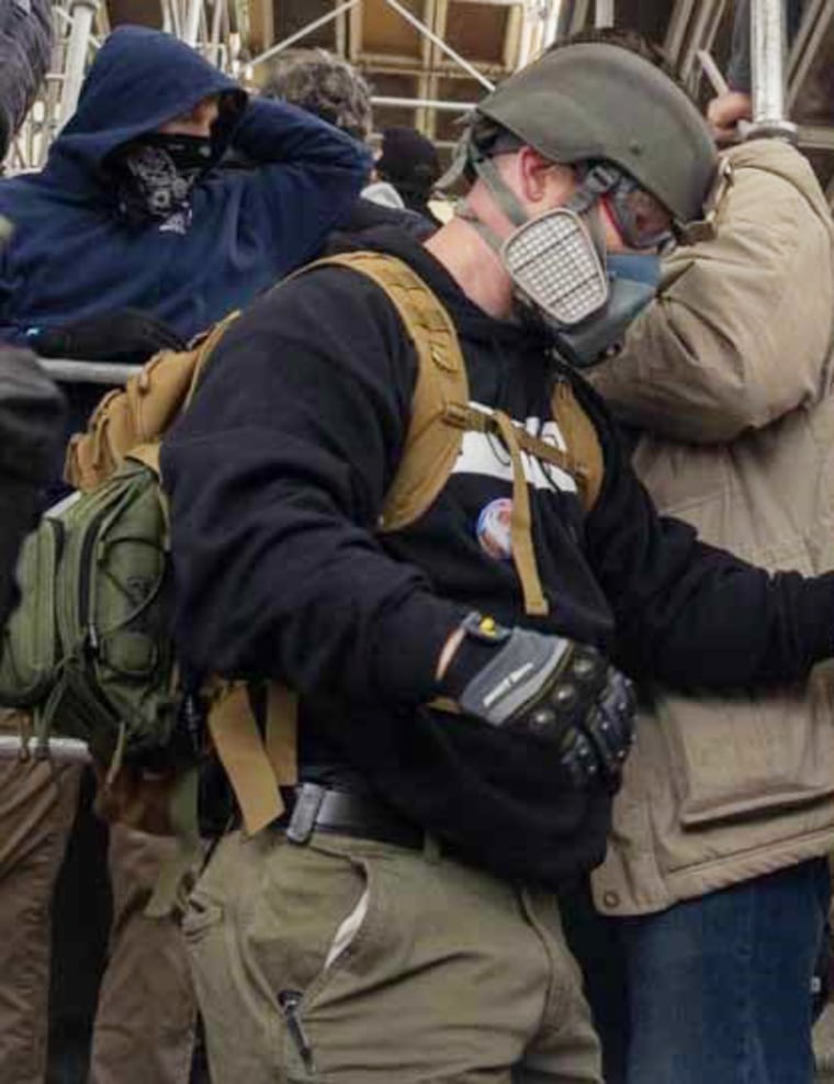 Kelley, in a gas mask, at the Capitol on Jan. 6, 2021, according to the FBI.