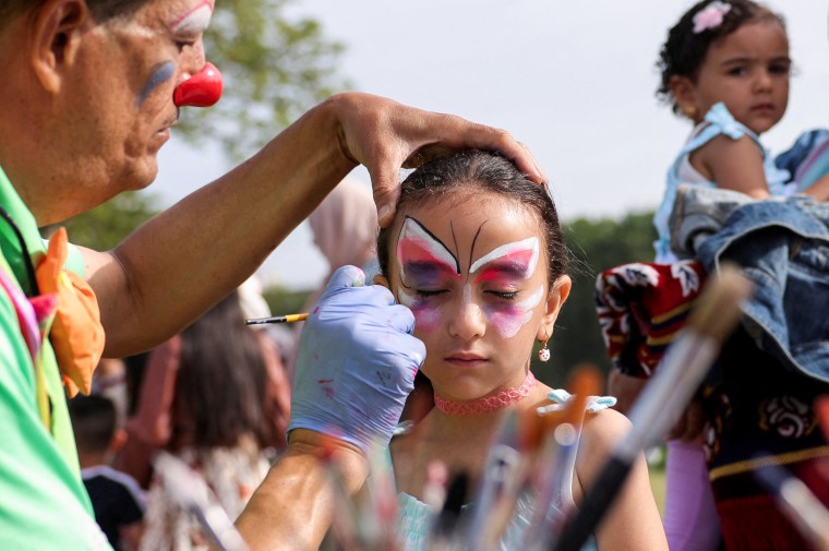 A girl has her face painted during a festival for the Muslim holiday Eid al-Adha in New York.