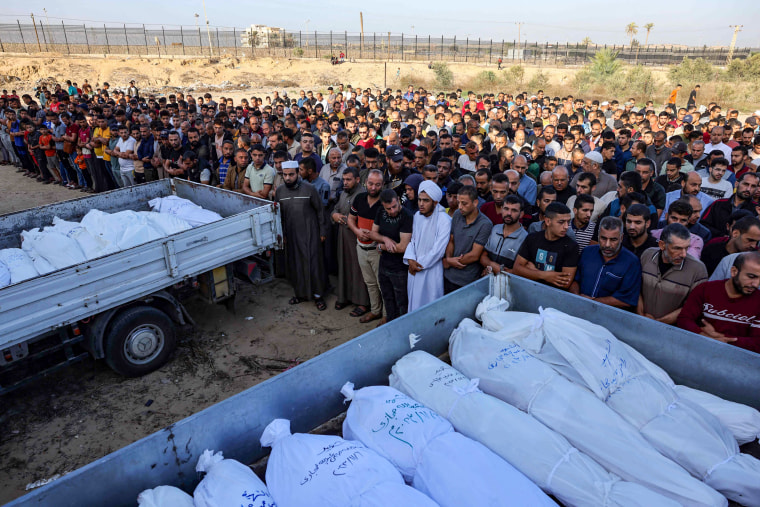 Palestinians pray near the bodies of members of the Hijazi family in Rafah, in the southern Gaza Strip.