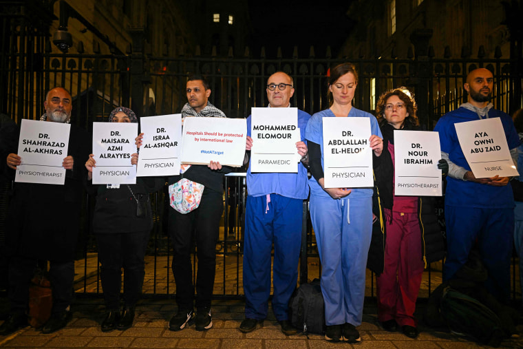 Healthcare workers hold a vigil on Downing Street in London for healthcare workers killed in Gaza.