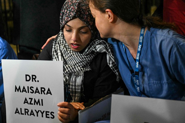 Healthcare workers hold a vigil on Downing Street in London for healthcare workers killed in Gaza.