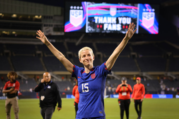 Megan Rapinoe cheers as she leaves the pitch after a soccer match