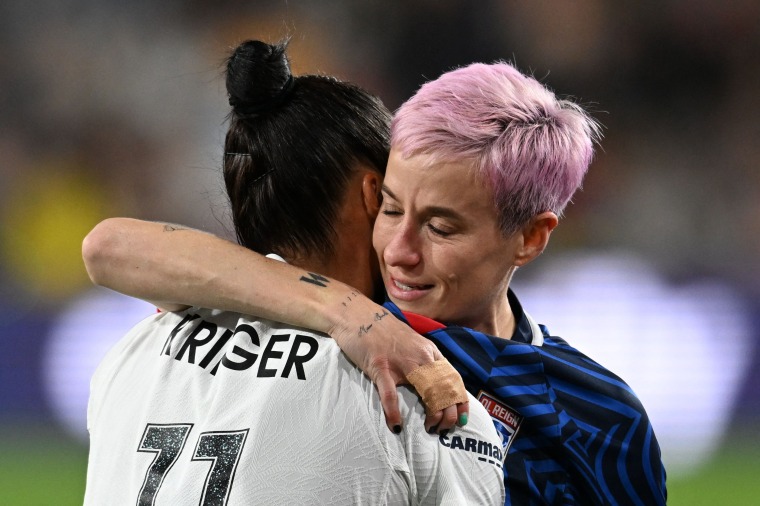 Gotham FC's Ali Krieger hugs OL Reign's Megan Rapinoe as she is helped off the pitch after an injury in the early minutes of the National Women's Soccer League final match between the two teams at Snapdragon Stadium in San Diego, California, on Nov. 11, 2023.