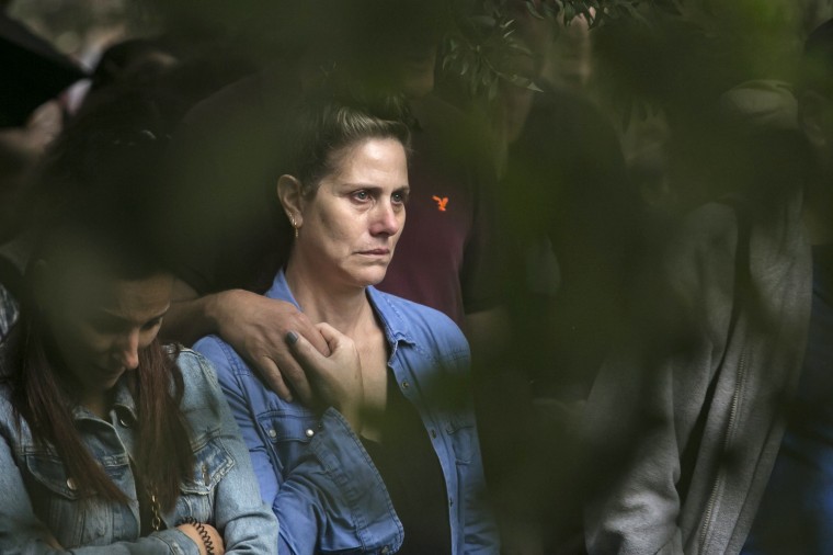 Family and friends mourn during the funeral of fallen soldier, staff Sgt. Gilad Rozenblit, killed in the Gaza Strip, on Nov. 12, 2023 in Ginegar, Israel. More than 40 Israeli soldiers have been publicly announced as being killed since the country began its ground invasion of the Gaza Strip.