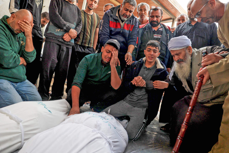 Relatives mourn over the bodies of loved ones killed during overnight strikes in Rafah in the southern Gaza Strip on Nov. 12, 2023.