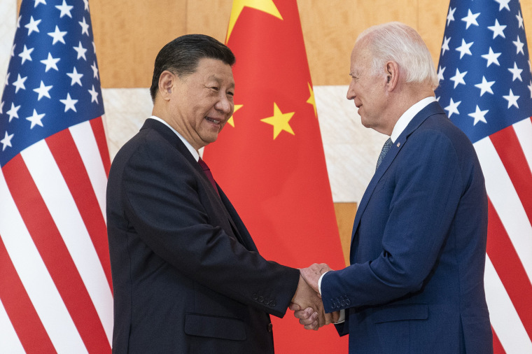 Xi Jinping and Joe Biden shake hands.