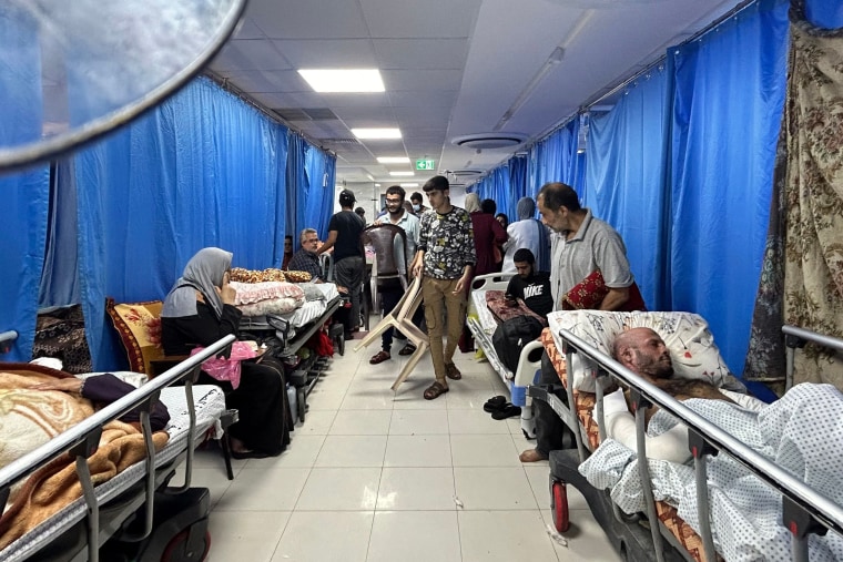 Patients and internally displaced people crowd into at Al-Shifa hospital on Friday.