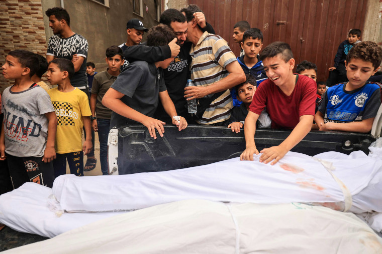 People mourn during the funeral of members of the Qudaih and Alshrafi families killed in overnight strikes in Khan Younis, Gaza.