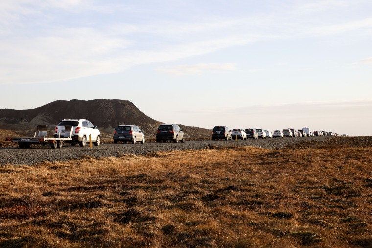 A line of cars lined the road heading to Grindavik, Iceland on November 13, 2023. Residents of Grindavik, a town in southwestern Iceland, were briefly allowed to return to their homes on Monday after they were told to evacuate on Saturday following a surge in numbers.  Fears of a possible volcanic eruption prompted civil defense authorities to declare a state of emergency in the region.