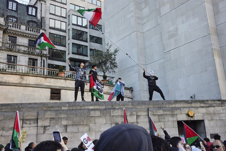 Protesters stand on a the roof of a building at a march demanding a  ceasefire in Gaza on Nov. 11, 2023 in London.