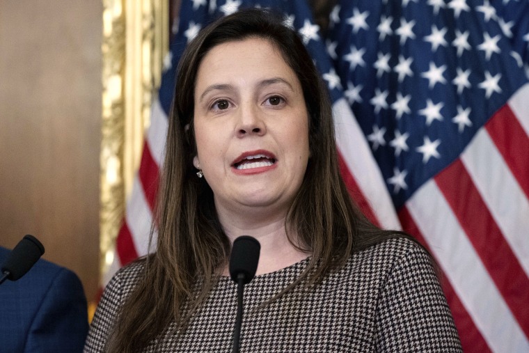 Rep. Elise Stefanik speaks in front of an American flag at a press conference at the Capitol