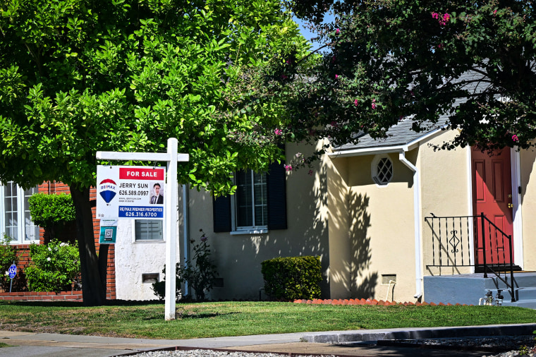 A For Sale sign is posted in front of a home for sale in San Marino, Calif.