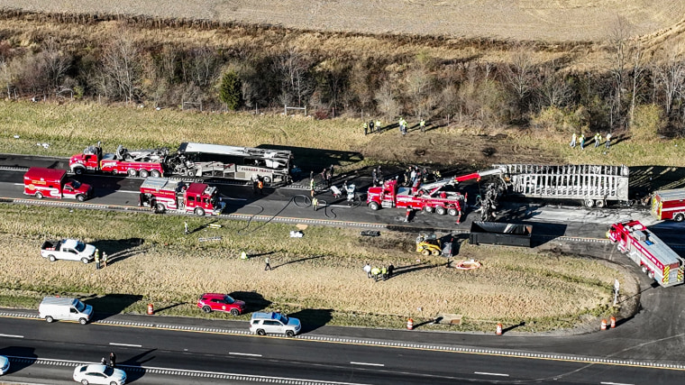 Tow trucks begin to remove the wreckage between a chartered bus carrying band students and several other vehicles on I-70 near Etna, Ohio