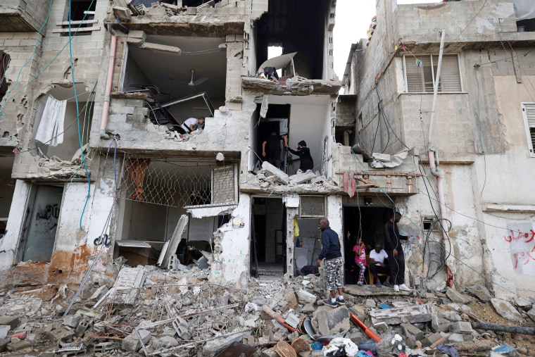Palestinians inspect destroyed homes in the Tulkarem refugee camp in the occupied West Bank after the withdrawal of the Israeli army following a military operation on Nov. 14, 2023. 