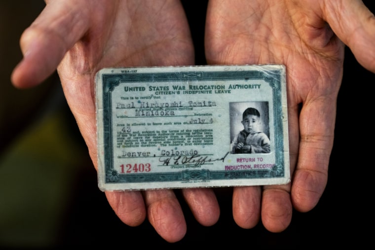 Paul Tomita displays a copy of his exit card in Twin Falls, Idaho