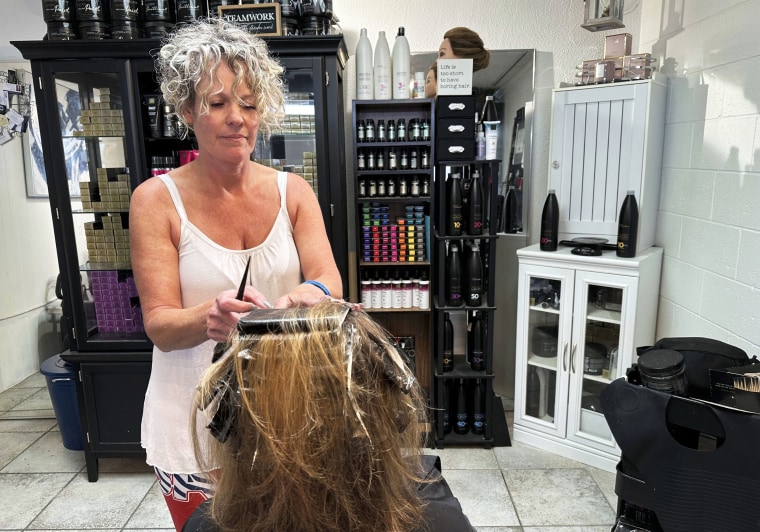 Christine Geiger cuts a customer's hair.