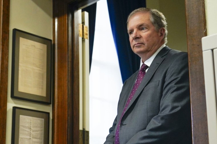 David Scanlan leans against a door frame in his office