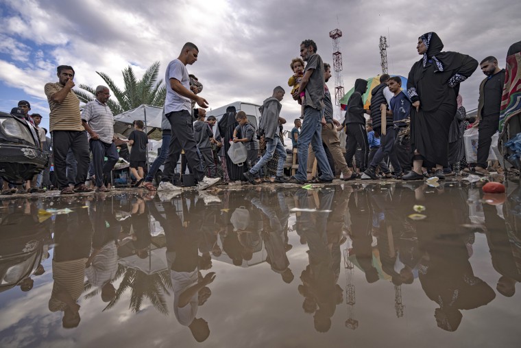 Displaced Palestinians walk in a United Nations tent camp in Khan Younis, Gaza, on Nov. 15, 2023.