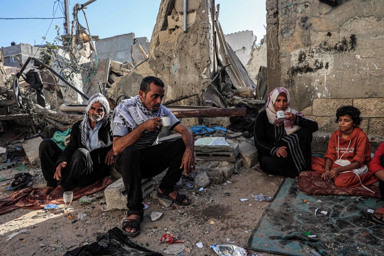 A family drinks tea in Rafah, southern Gaza.