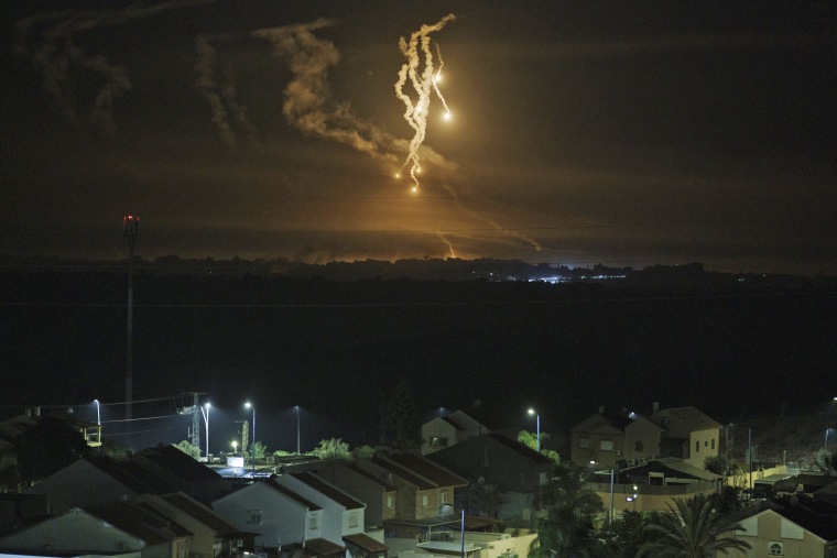 Flares rise over the Gaza Strip as seen from southern Israel, foreground., on Nov. 15, 2023. 