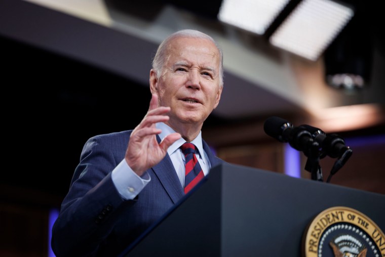 President Joe Biden speaks at a podium during an event in the Eisenhower Executive Office Building