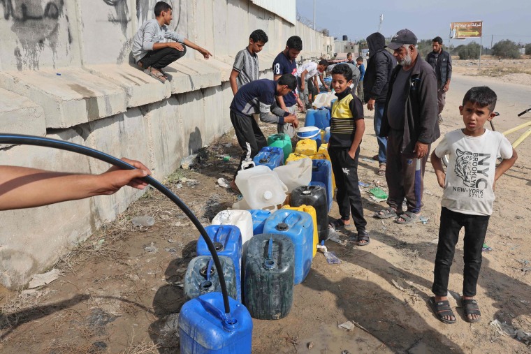 Palestinian children fill containers with water in Rafah, southern Gaza, on Nov. 13, 2023.