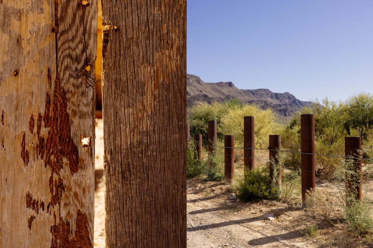 Bullet holes visible in the wooden walls of Raymond Mattia’s house; The border, marked only by metal stakes pounded into the desert.