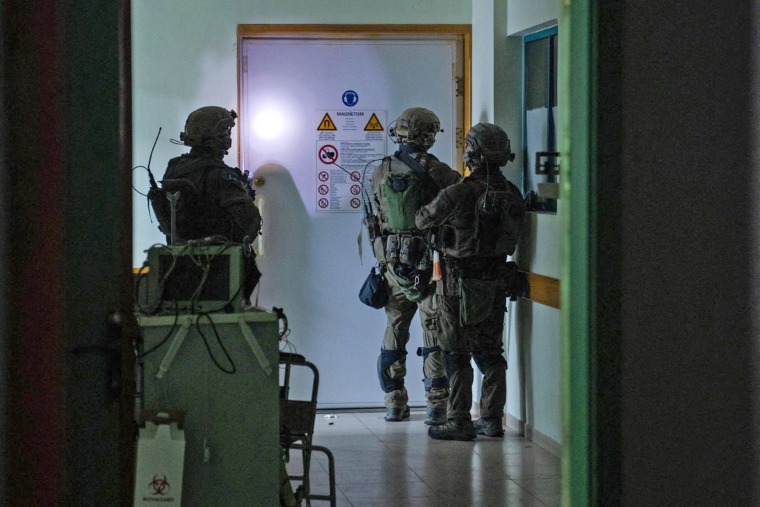 A photo released Wednesday by the Israeli army shows soldiers carrying out operations inside Al-Shifa hospital in Gaza City.