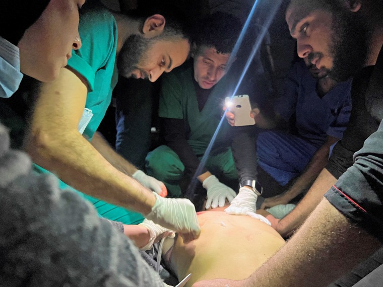 Palestinians wounded in Israeli strikes are assisted at the Indonesian hospital