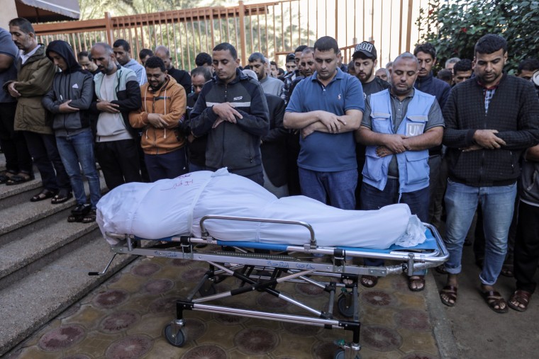 Palestinians mourn while collecting bodies on Nov. 16, 2023 in Khan Younis, southern Gaza. 