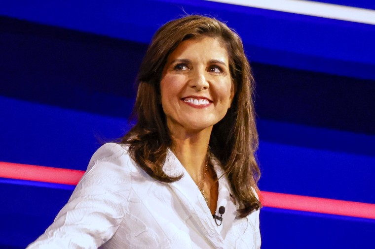 Former Gov. Nikki Haley walks onstage smiling at the Republican primary presidential debate