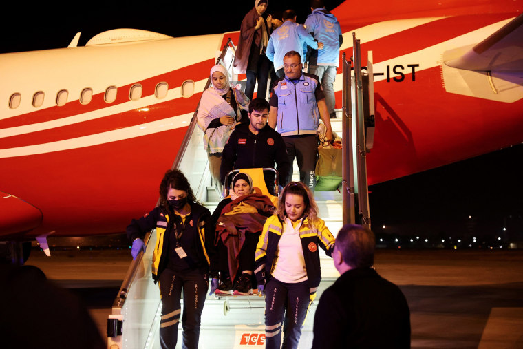 A Palestinian cancer patient, who had crossed from Gaza into Egypt, disembarks the plane on a wheelchair after arriving at the Esenboga Airport in Ankara on November 16, 2023. 