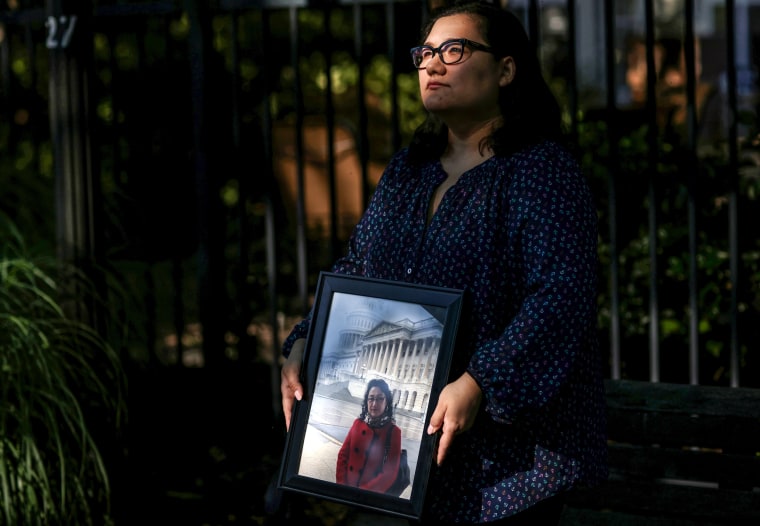 Ziba Murat holds a photo of her mother Gulshan Abbas in Virginia on June 16, 2021.