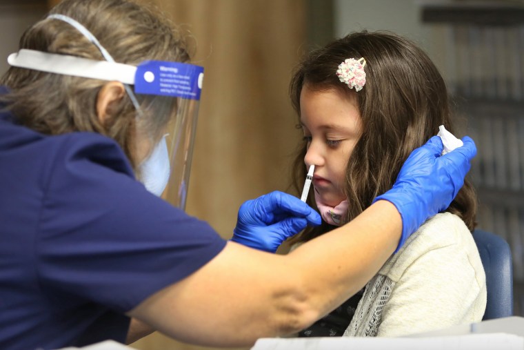 Ivy Kirschke, 7, receives the FluMist mist vaccine in Gainesville, Fla., in October.