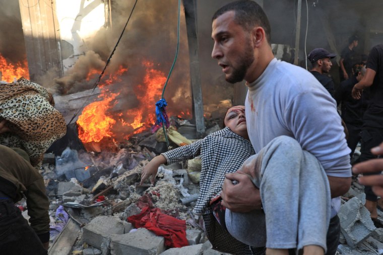 A man evacuates a wounded girl after a bombardment in Rafah in the southern Gaza Strip on Nov. 17, 2023.