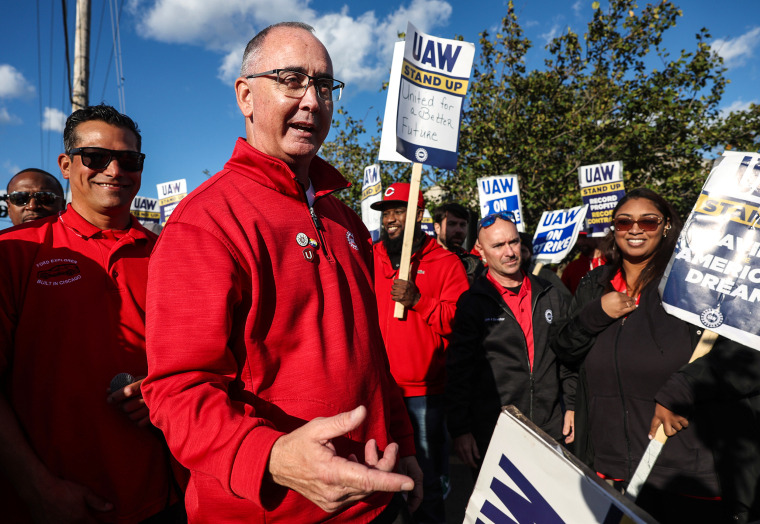 United Auto Workers President Shawn Fain, middle, visits striking UAW Local 551 workers outside a Ford assembly center