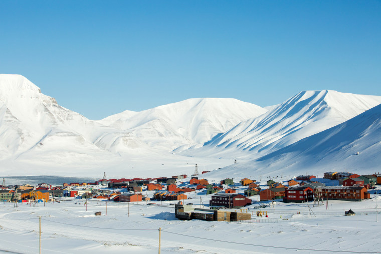 Small town Longyearbyen among snow-capped mountains