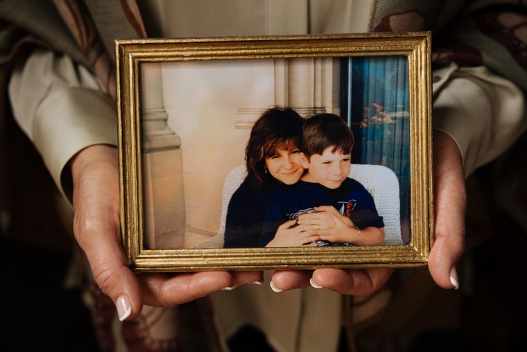 Linda Clary holds a family photo of both herself and her son John Umberger.