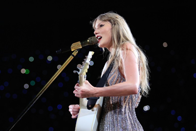 Taylor Swift guitar and sings onstage